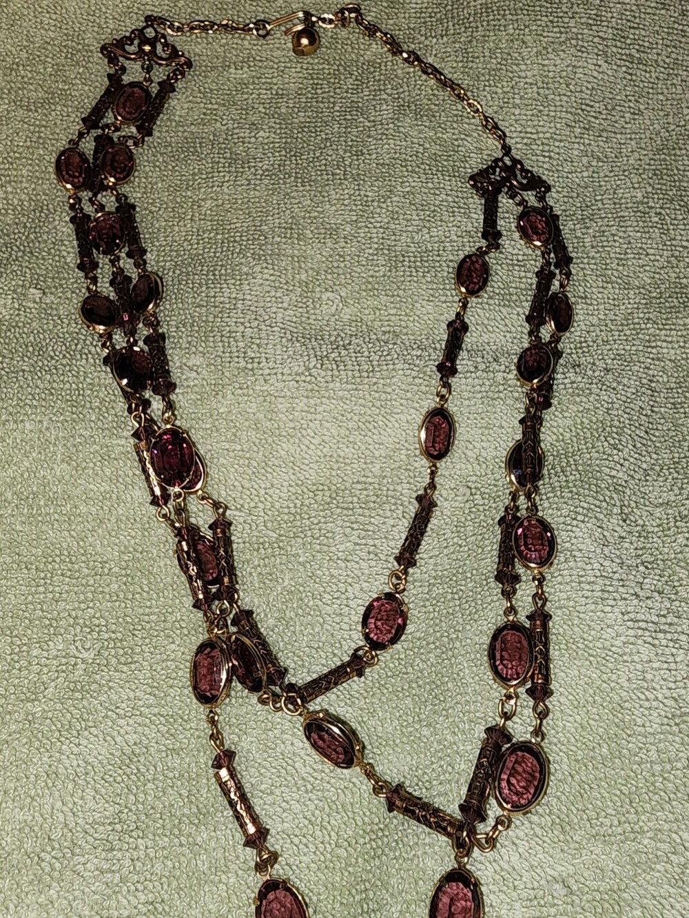 vintage multi-strand necklace with ornate gold-tone chains and textured